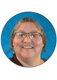 Smiling person with glasses on blue background.