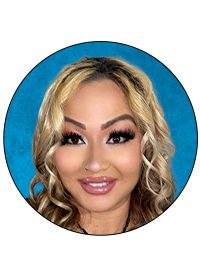 Smiling woman with curly blonde hair.