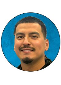 Smiling man against blue background, circular frame.