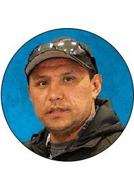 A man wearing a hat and jacket.
